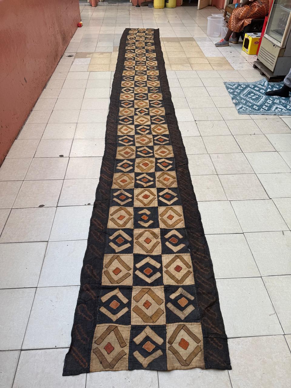 Handwoven African wall hanging with radial cultural pattern